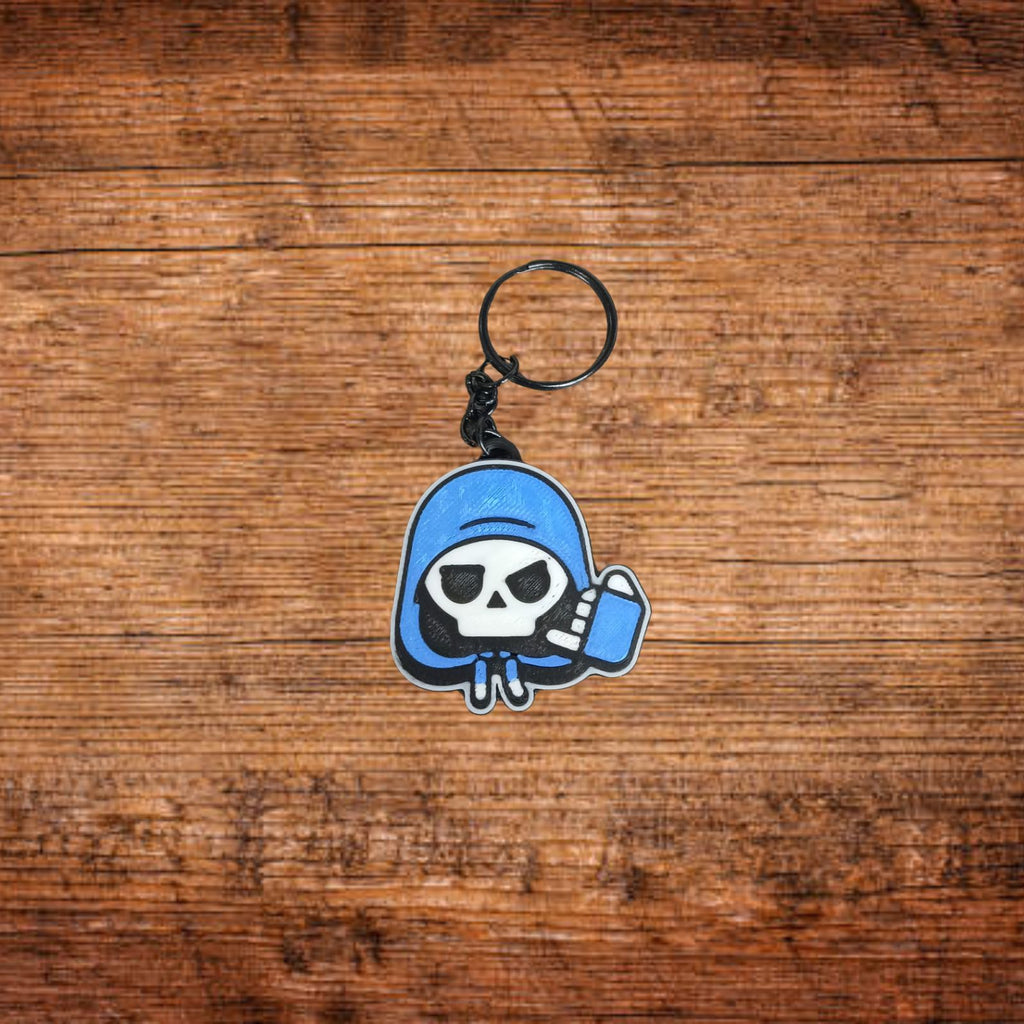 Schlüsselanhänger mit Totenkopf-Motiv in blauer Kapuzenform, mit Ring und Kette