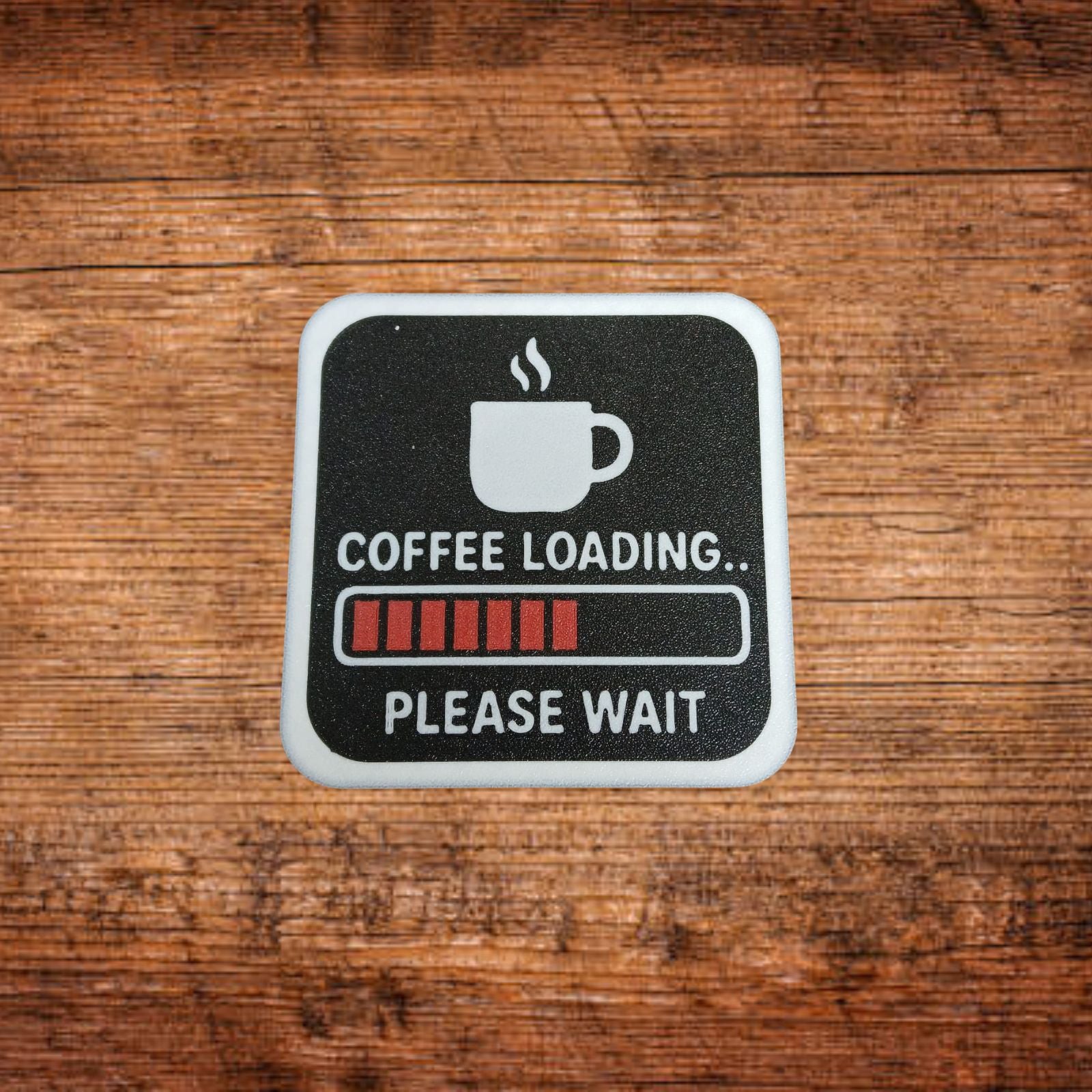 Schwarzer Untersetzer mit weißem Rand und Kaffee-Loading-Design
