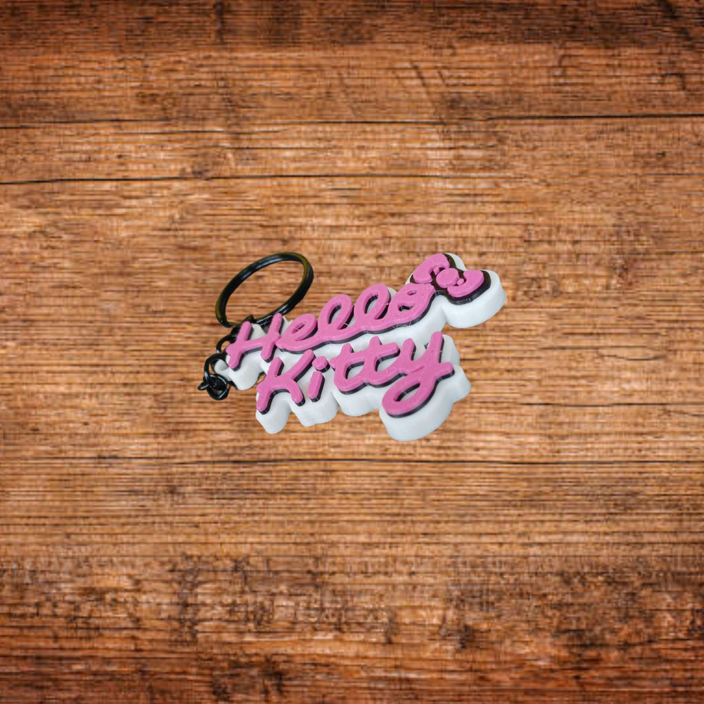 Hello Kitty Schlüsselanhänger, rosa-weiße Schrift, schwarzer Ring