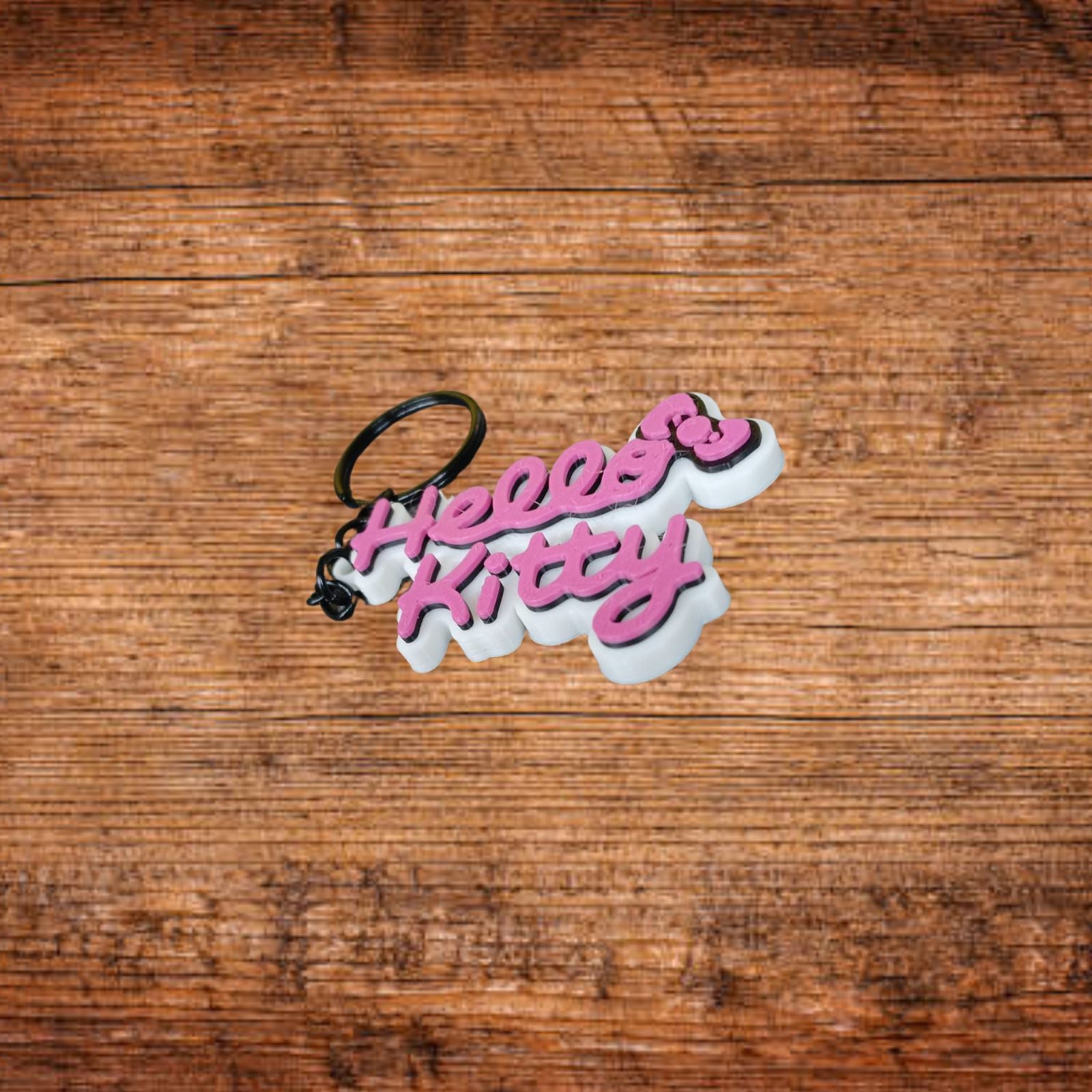 Hello Kitty Schlüsselanhänger, rosa-weiße Schrift, schwarzer Ring