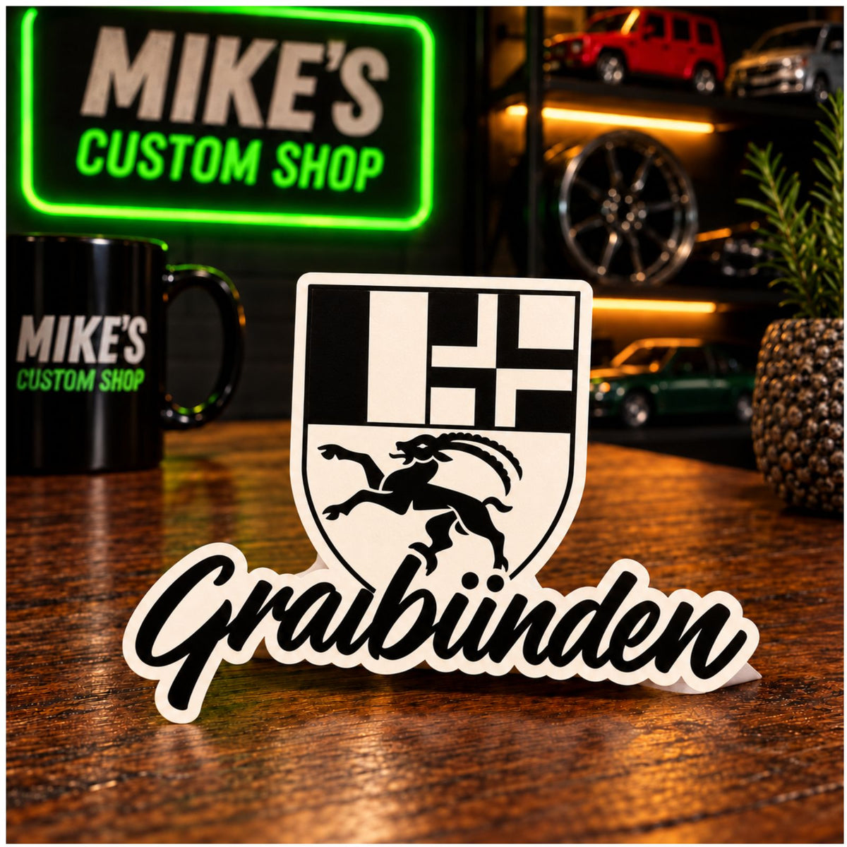 Sticker mit Kantonswappen und „Graubünden“-Schrift, weiß konturiert, schwarz