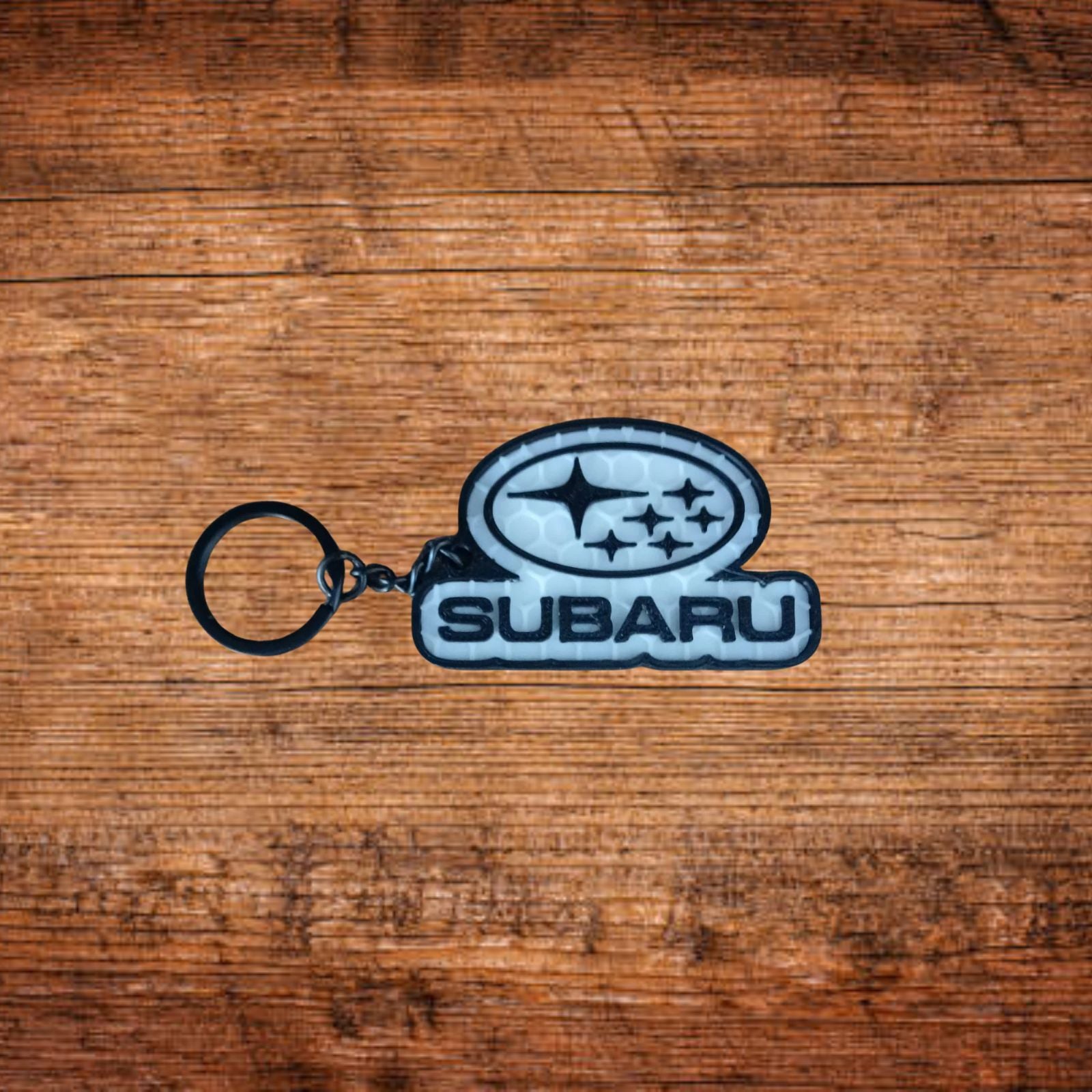 Subaru Schlüsselanhänger mit ovalem Logo und schwarzem Ring