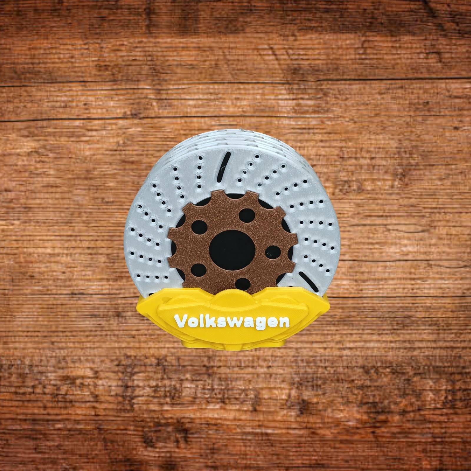 Bremsattel-Untersetzer mit weißer Bremsscheibe und gelbem Volkswagen-Einsatz