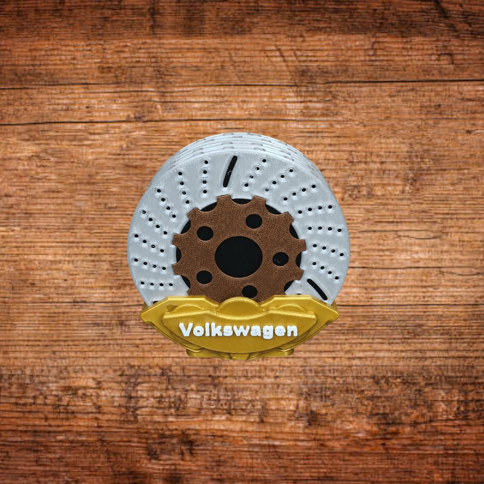 Bremsattel-Untersetzer mit weißer Bremsscheibe und goldgelbem Volkswagen-Einsatz