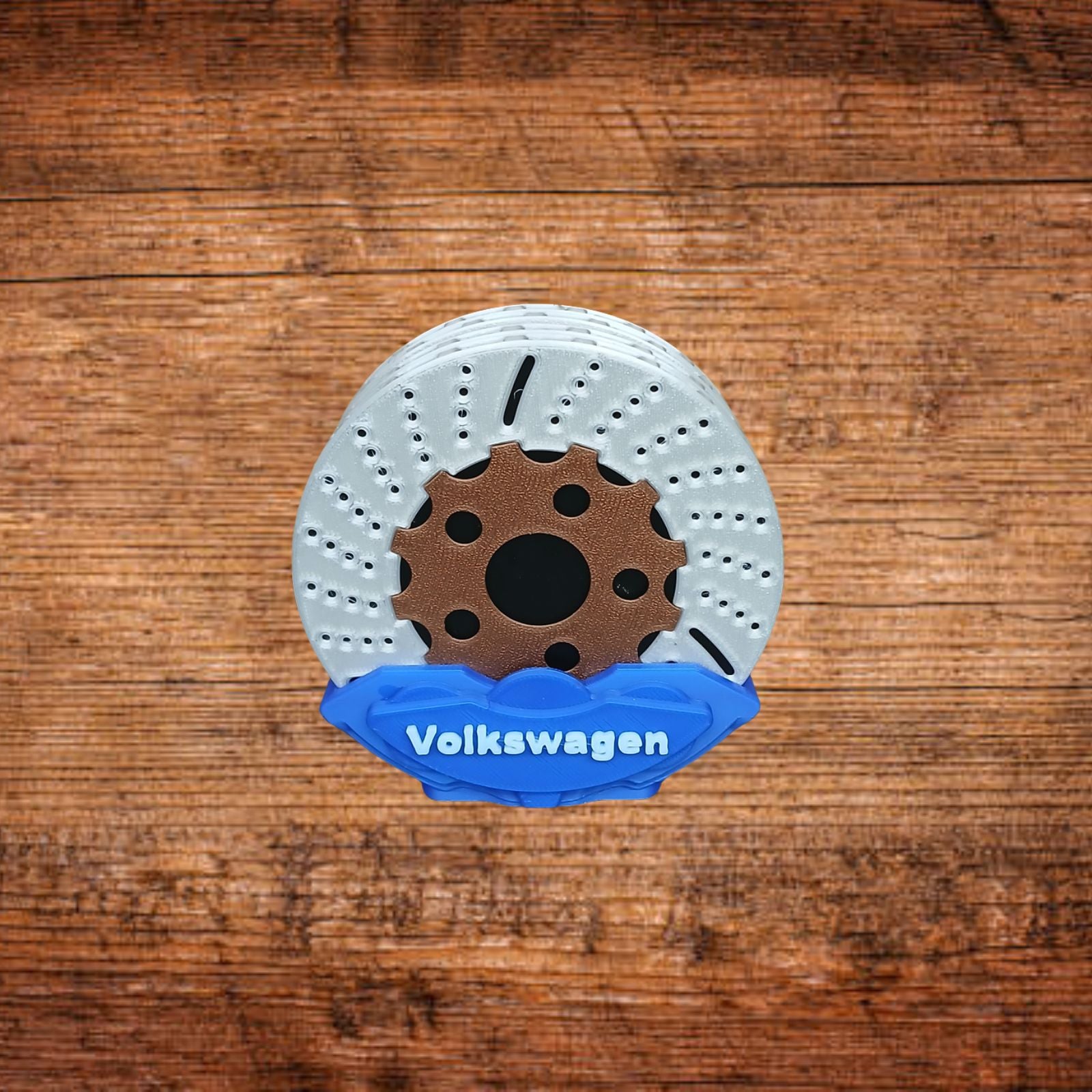 Bremsattel-Untersetzer mit weißer Bremsscheibe und blauem Volkswagen-Einsatz