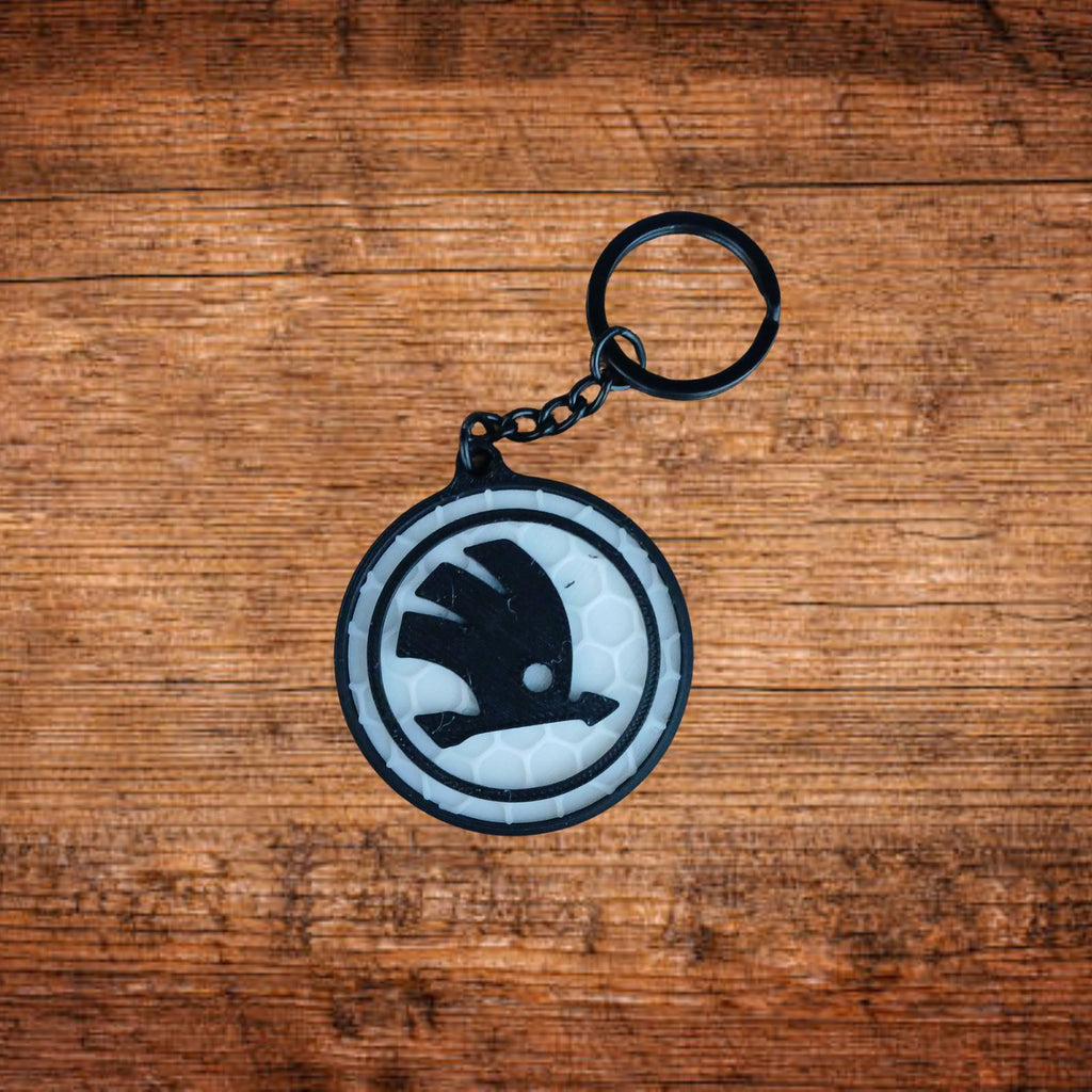 Škoda Schlüsselanhänger, rund, weiß/grau mit schwarzem Symbol