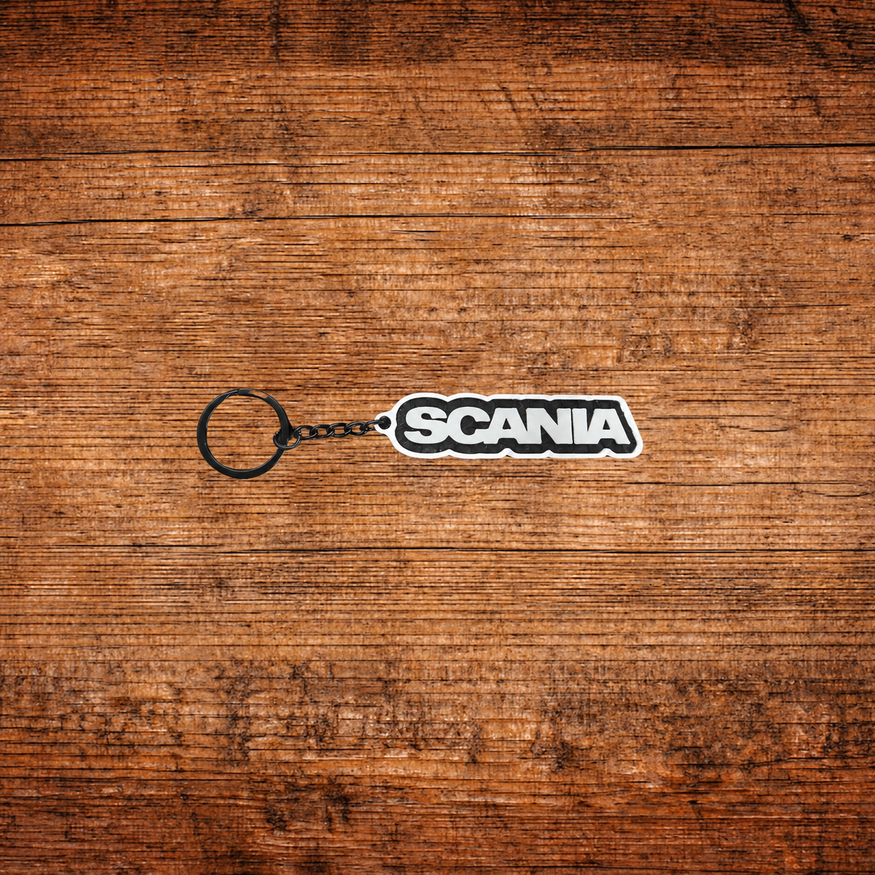 Scania-Schlüsselanhänger mit Schriftzug, weißes Schild mit schwarzem SCANIA